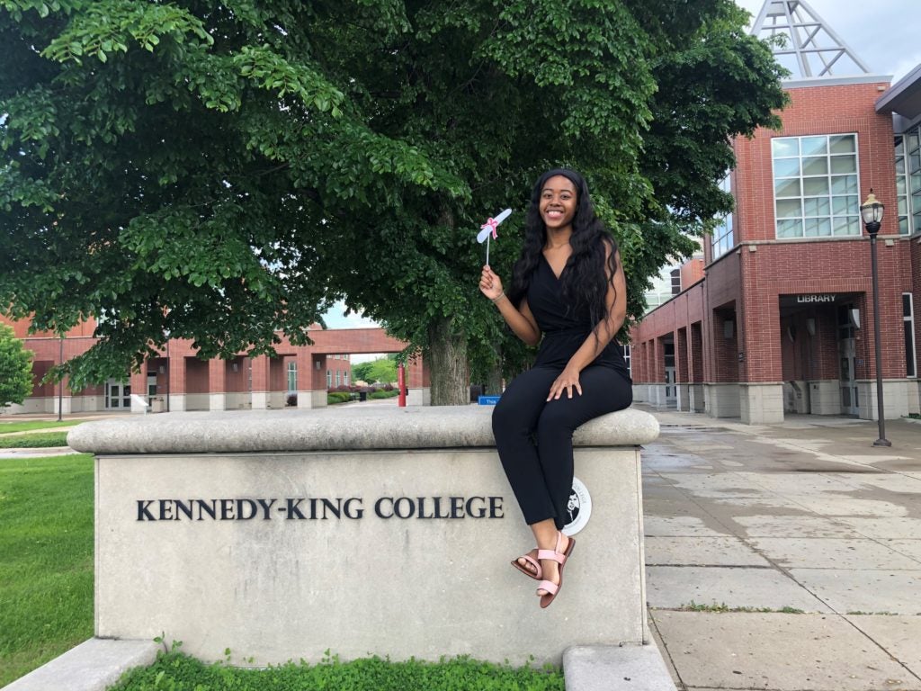 Student sitting in front of Kennedy-King College