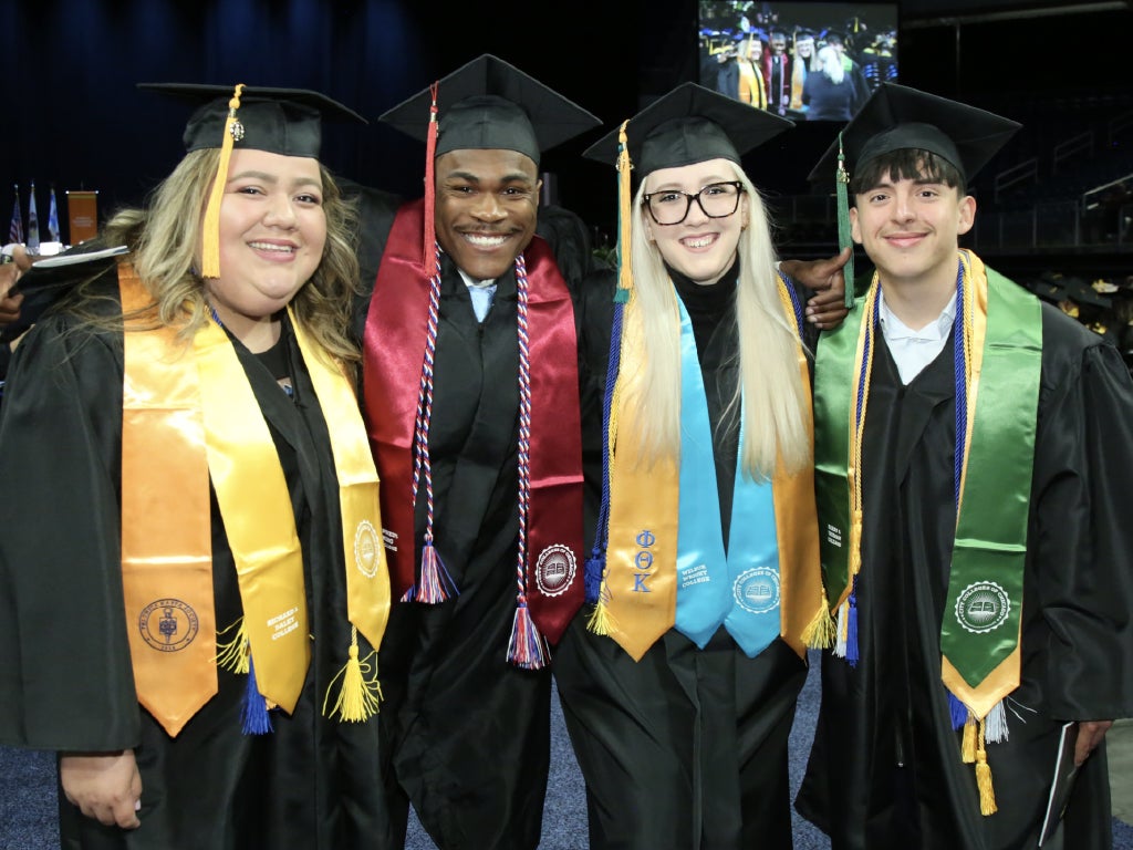 Path Bachelors Graduates in caps and gowns at a commencement ceremony